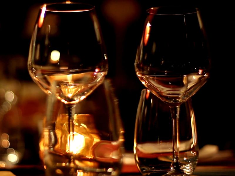 Prikaz vinskih čaša i sveća u restoranu na stolu